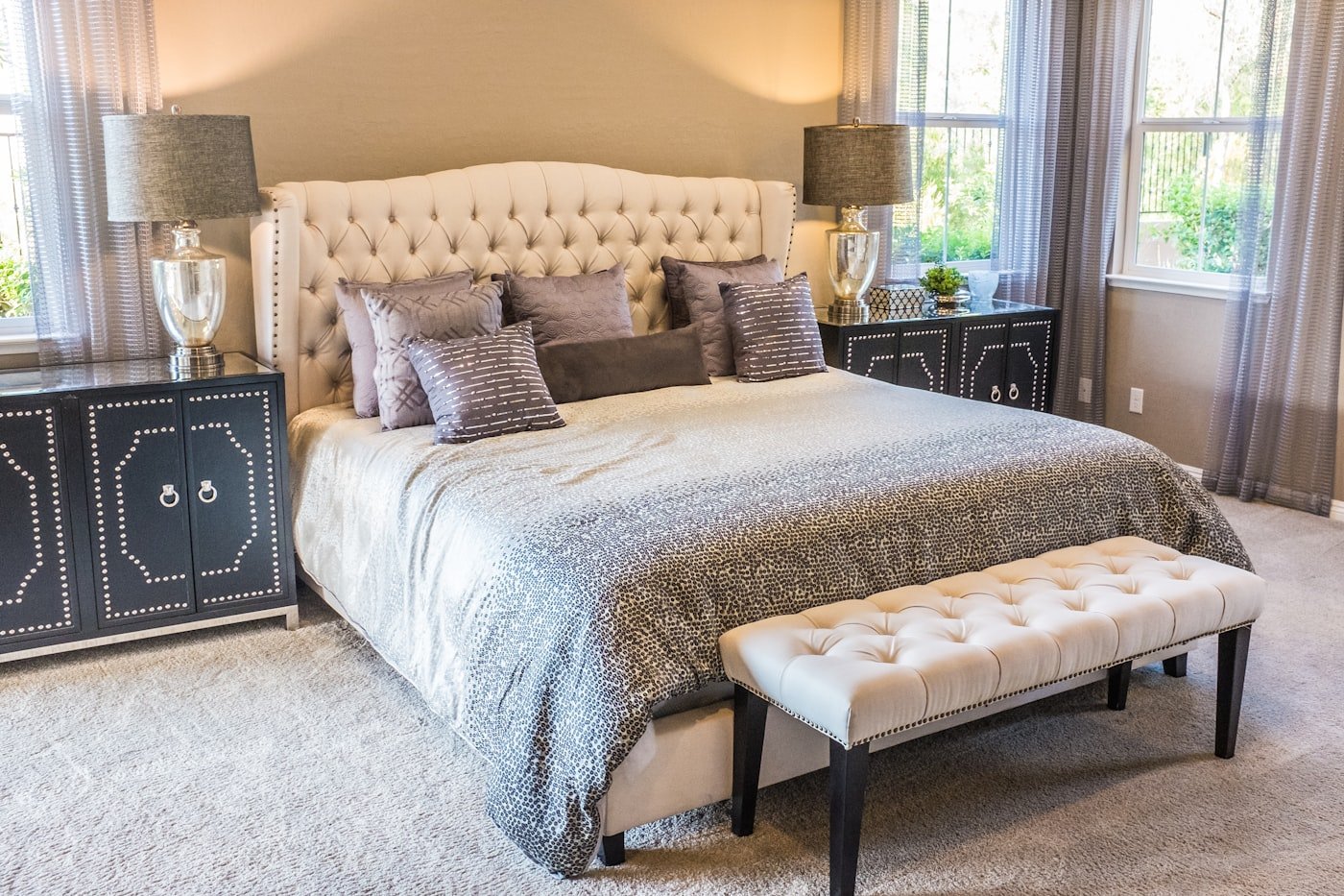 A clean bedroom with a mattress and bedding pulled back for inspection